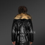 Long leather jacket in black for women with detachable raccoon fur collar with Model back side view