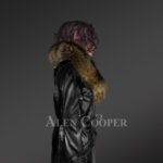 Long leather jacket in black for women with detachable raccoon fur collar with Model side view
